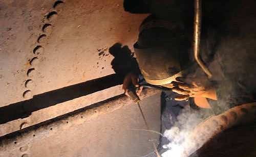 Welder Ron Mortimer works on repairing Australia’s only operational steam winding engine of its type, at the Gympie Mining Museum. Welder Ron Mortimer works on repairing Australia’s only operational steam winding engine of its type, at the Gympie Mining Museum.